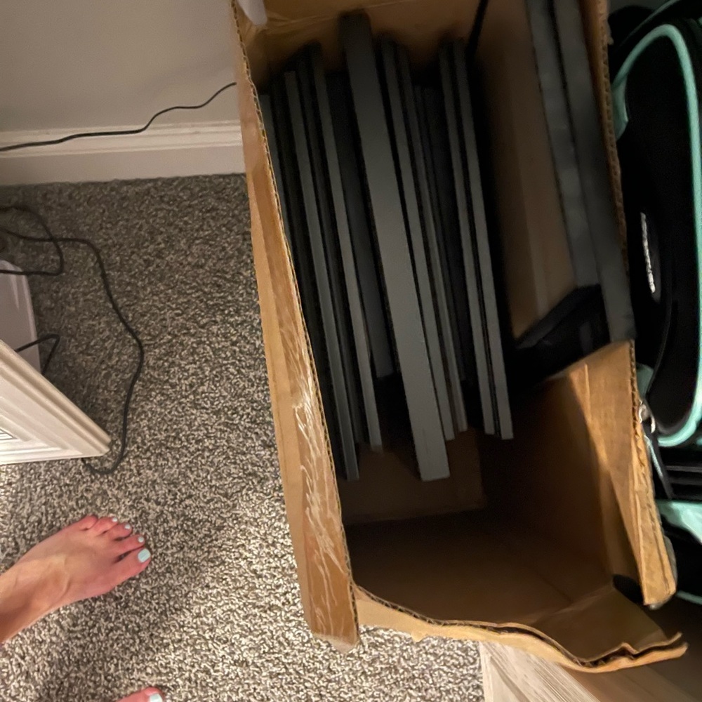 Lot of mostly black picture frames. A few blue and white.